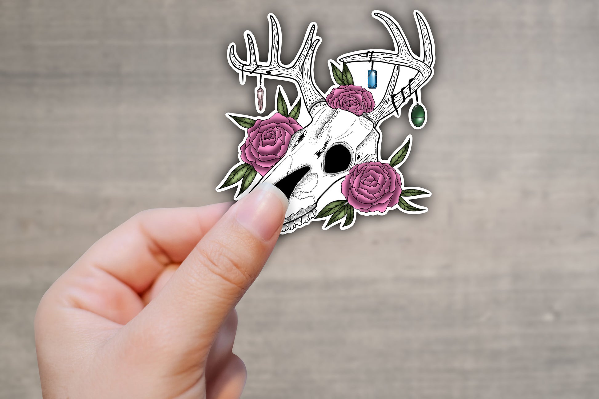 Hand holding deer skull vinyl sticker